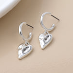 Silver plated worn finish heart hoop earrings