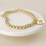 Golden beaded heart charm bracelet with pave crystal star