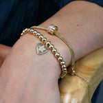Golden beaded heart charm bracelet with pave crystal star