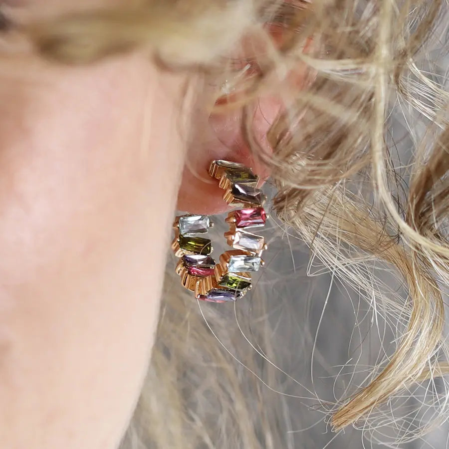 Golden staggered multicoloured crystal hoop earrings
