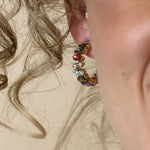 Golden staggered multicoloured crystal hoop earrings