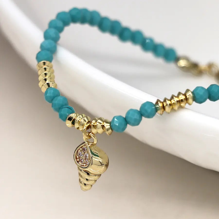 Golden shell charm and turquoise bead bracelet