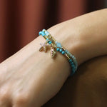 Golden shell charm and turquoise bead bracelet
