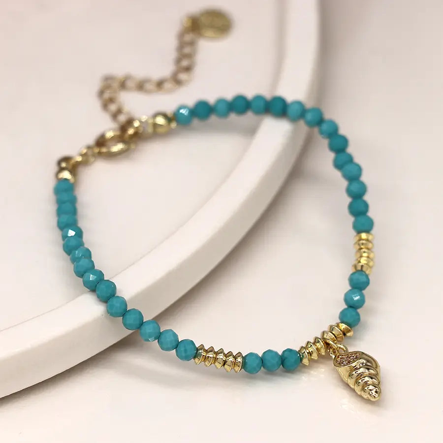 Golden shell charm and turquoise bead bracelet