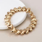 Golden worn hearts stretch bracelet