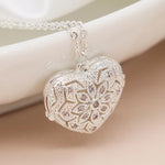 Silver plated heart shaped filigree and crystal locket