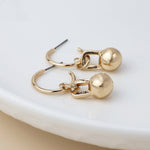 Golden c-hoop and ball charm earrings