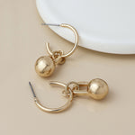 Golden c-hoop and ball charm earrings