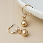 Golden c-hoop and ball charm earrings