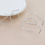 Silver plated mixed size textured heart earrings 4584